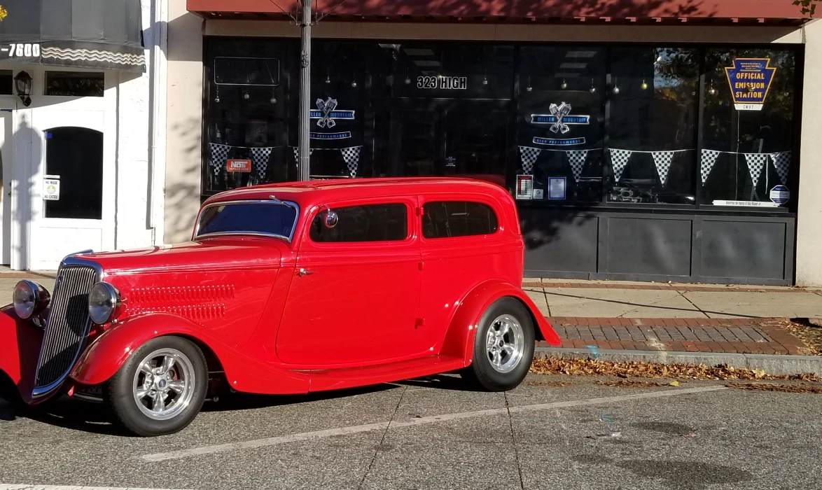 Red classic car in front of miller mountain high performance shop 1 Red classic car in front of miller mountain high performance shop